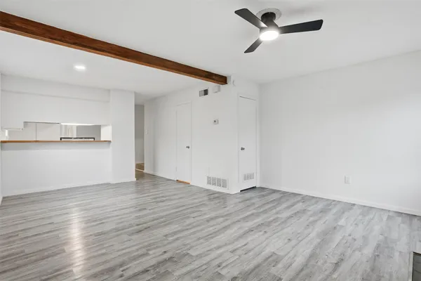 a view of a kitchen with wooden floor and a sink