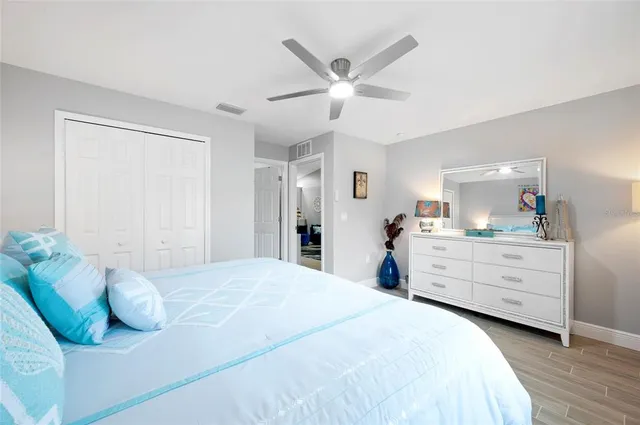 a bedroom with a bed and painting on the wall