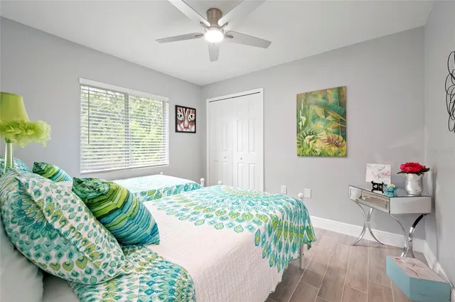 a bathroom with a bathtub shower sink vanity mirror and toilet