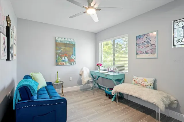 a living room with furniture and a potted plant