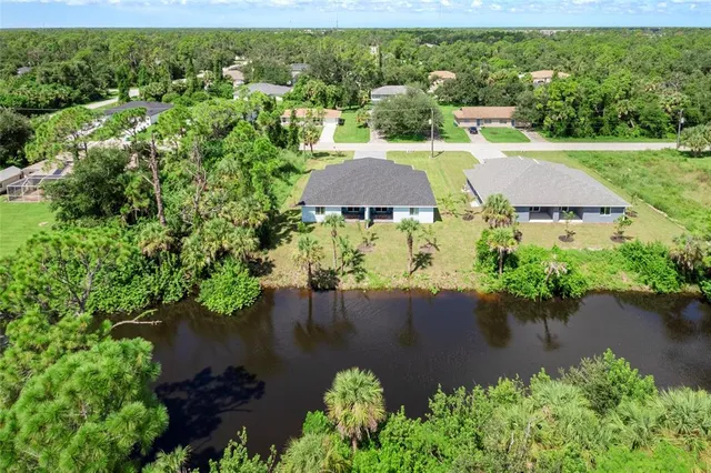 a view of a lake with houses in the back