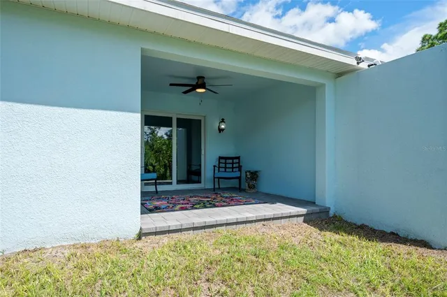 an aerial view of a house with a yard basket ball court and outdoor seating