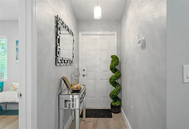 a kitchen with stainless steel appliances a sink a microwave a refrigerator and cabinets