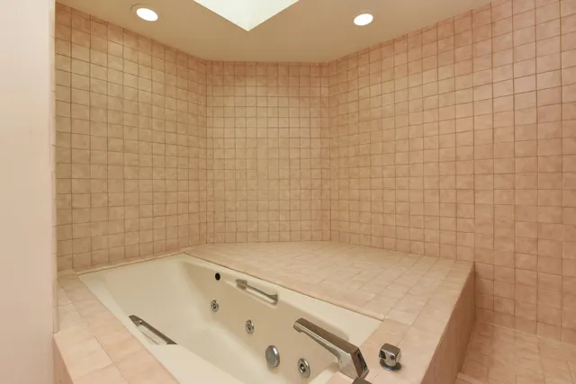 a bathroom with a tub and a shower