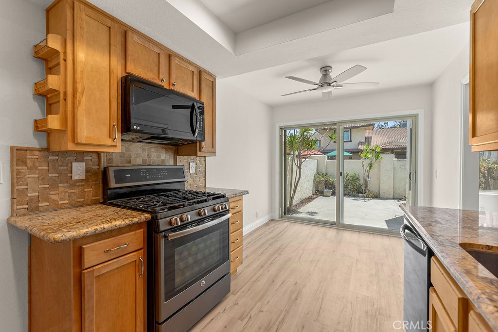 9866 Lido Way, Unit 20 Cypress, CA 90630 - Photo 12 of 24 a kitchen with a stove a sink and a microwave