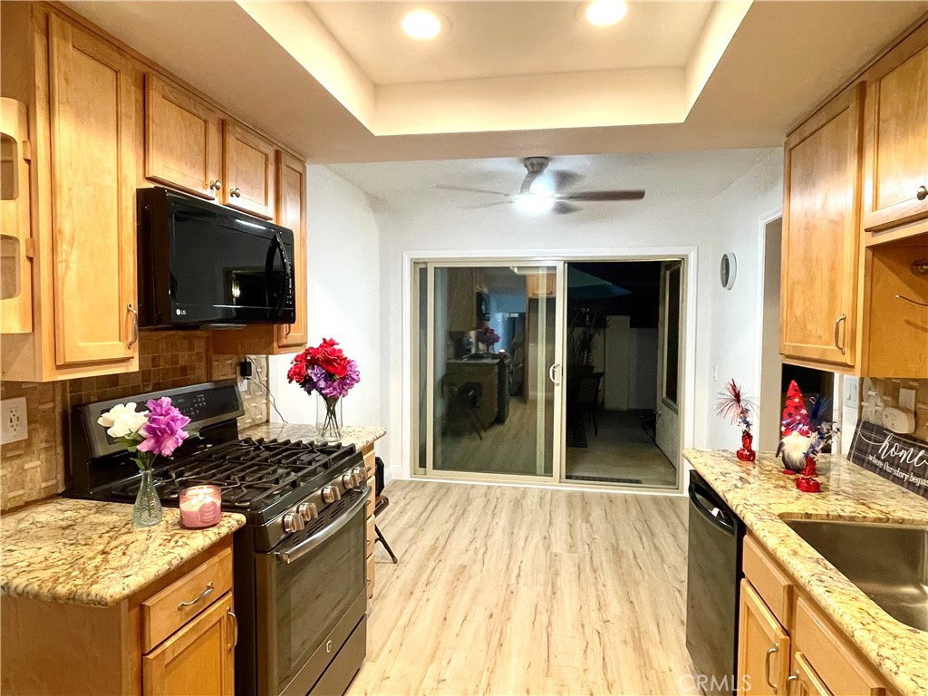9866 Lido Way, Unit 20 Cypress, CA 90630 - Photo 13 of 24 a kitchen with a stove and a sink