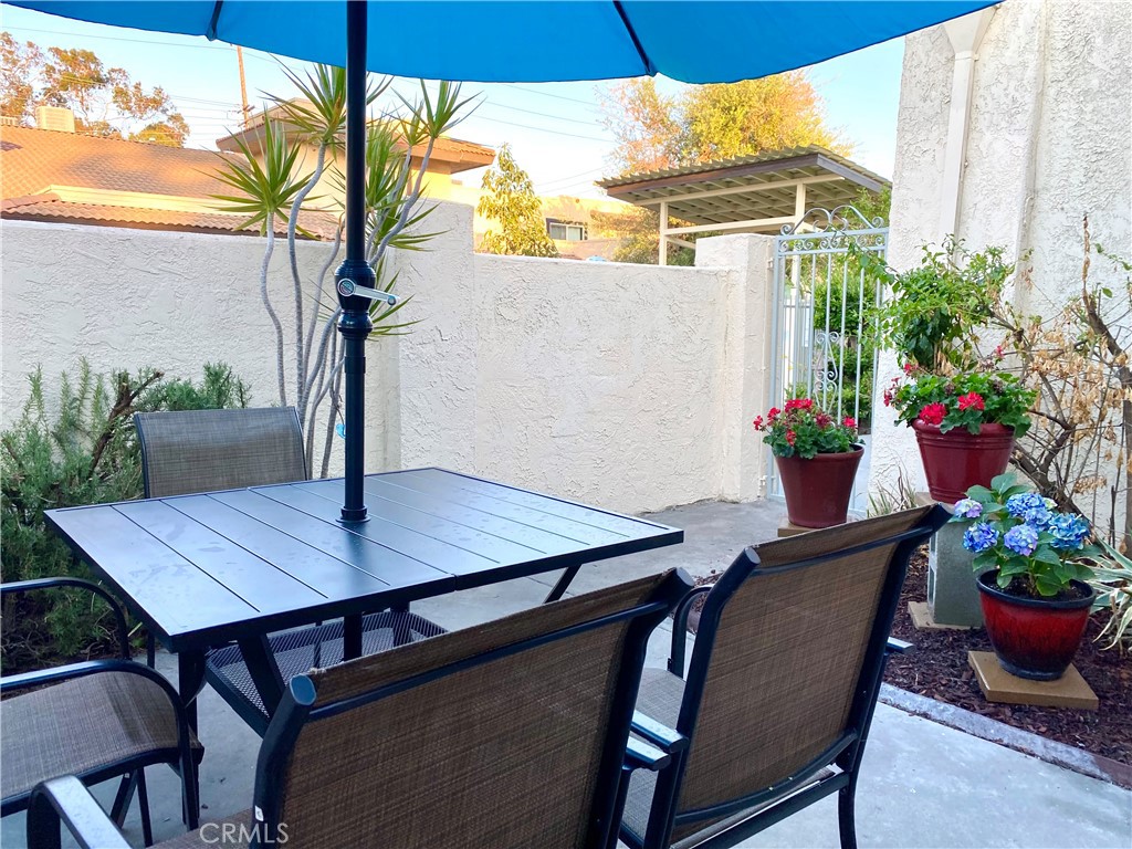 9866 Lido Way, Unit 20 Cypress, CA 90630 - Photo 17 of 24 a view of an outdoor dining space with a table and chairs