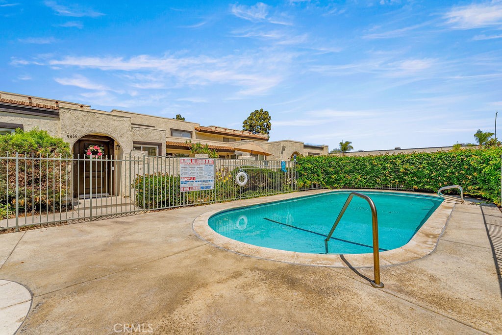 9866 Lido Way, Unit 20 Cypress, CA 90630 - Photo 21 of 24 a roof deck with table and chairs under an umbrella