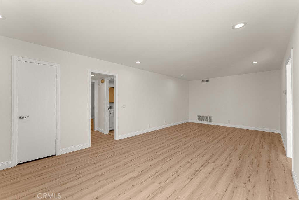 9866 Lido Way, Unit 20 Cypress, CA 90630 - Photo 4 of 24 a view of an empty room with wooden floor and closet