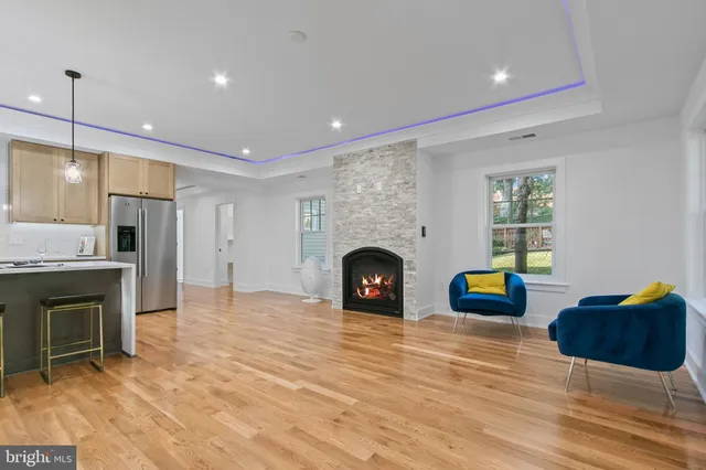 a view of a livingroom with a fireplace and windows