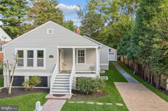 a kitchen with kitchen island granite countertop a sink a center island and stainless steel appliances