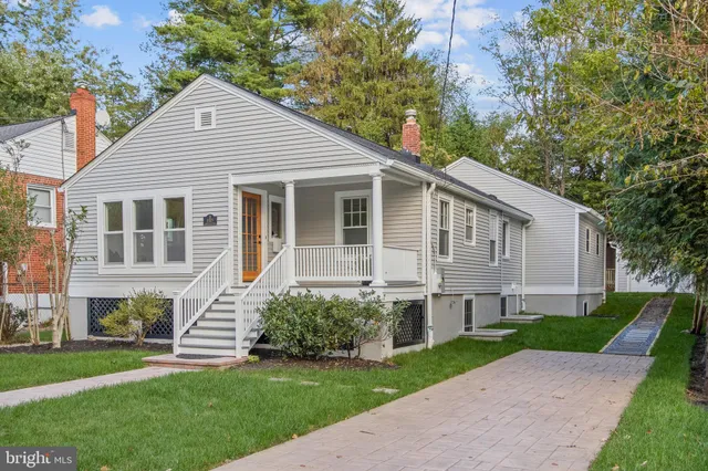 a kitchen with a sink a center island cabinets and stainless steel appliances