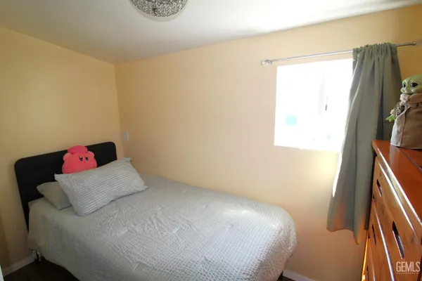 a bedroom with a bed and a chair