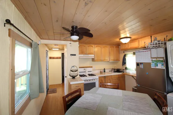 a kitchen with stainless steel appliances granite countertop a sink a stove and a refrigerator