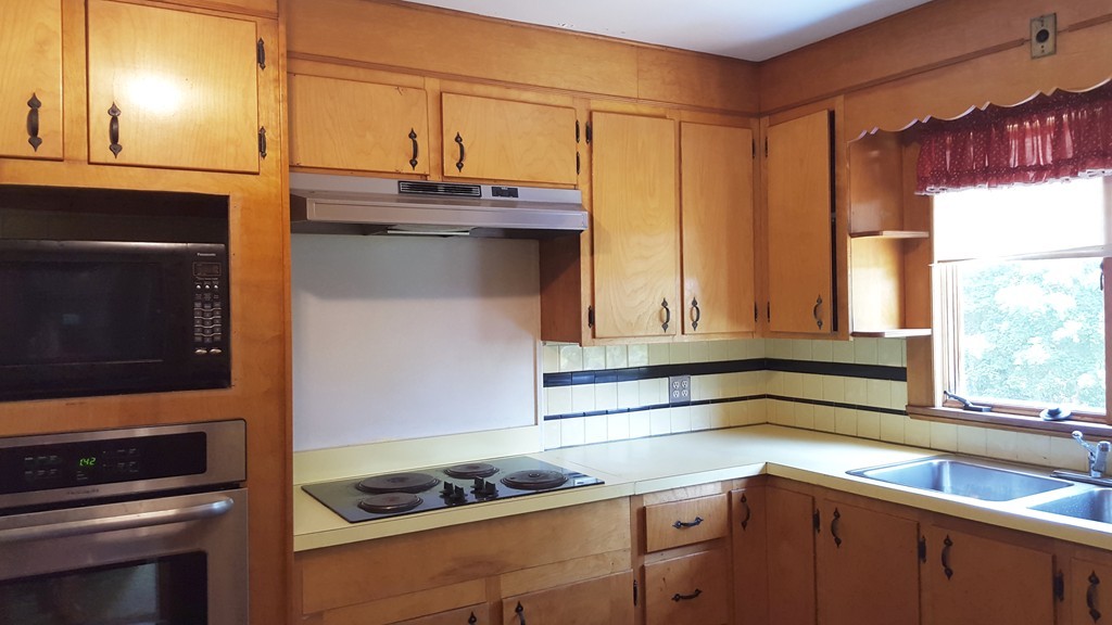 409 Lake Street Haverhill, MA 01832 - Photo 13 of 25 a kitchen with a sink and a stove