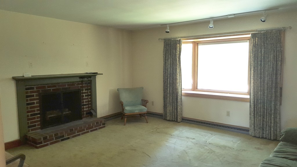 409 Lake Street Haverhill, MA 01832 - Photo 8 of 25 a room with a fireplace in it