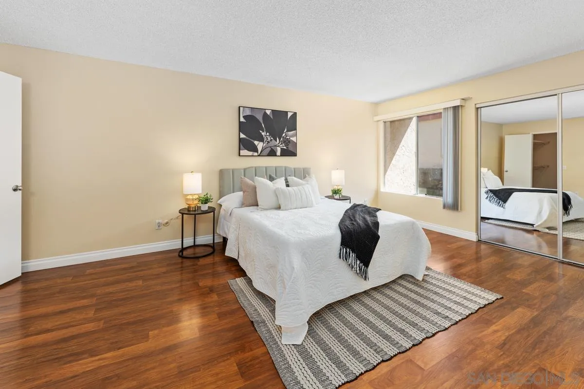 2332 Hosp Way, Unit 207 Carlsbad, CA 92008 - Photo 11 of 31 a bedroom with a bed and wooden floor