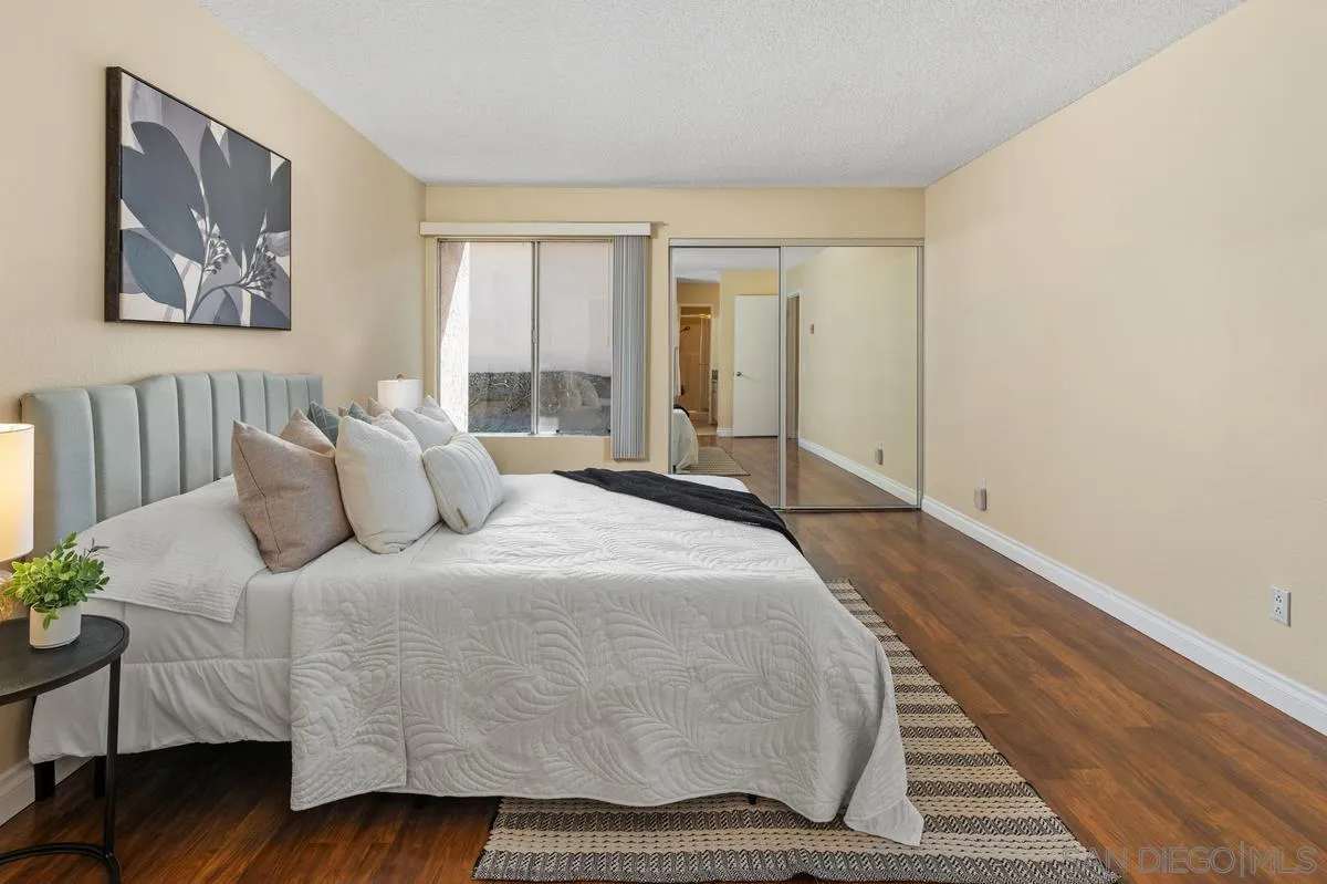 2332 Hosp Way, Unit 207 Carlsbad, CA 92008 - Photo 12 of 31 a spacious bedroom with a bed and wooden floor