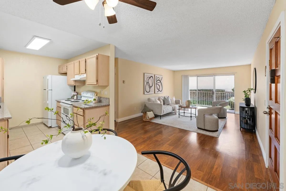 2332 Hosp Way, Unit 207 Carlsbad, CA 92008 - Photo 7 of 31 a living room with fireplace furniture and a wooden floor