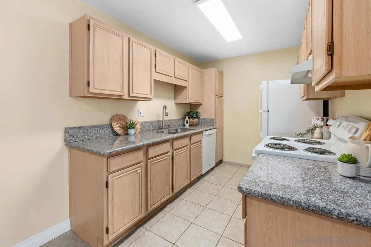 2332 Hosp Way, Unit 207 Carlsbad, CA 92008 - Photo 8 of 31 a kitchen with stainless steel appliances granite countertop a sink stove and cabinets