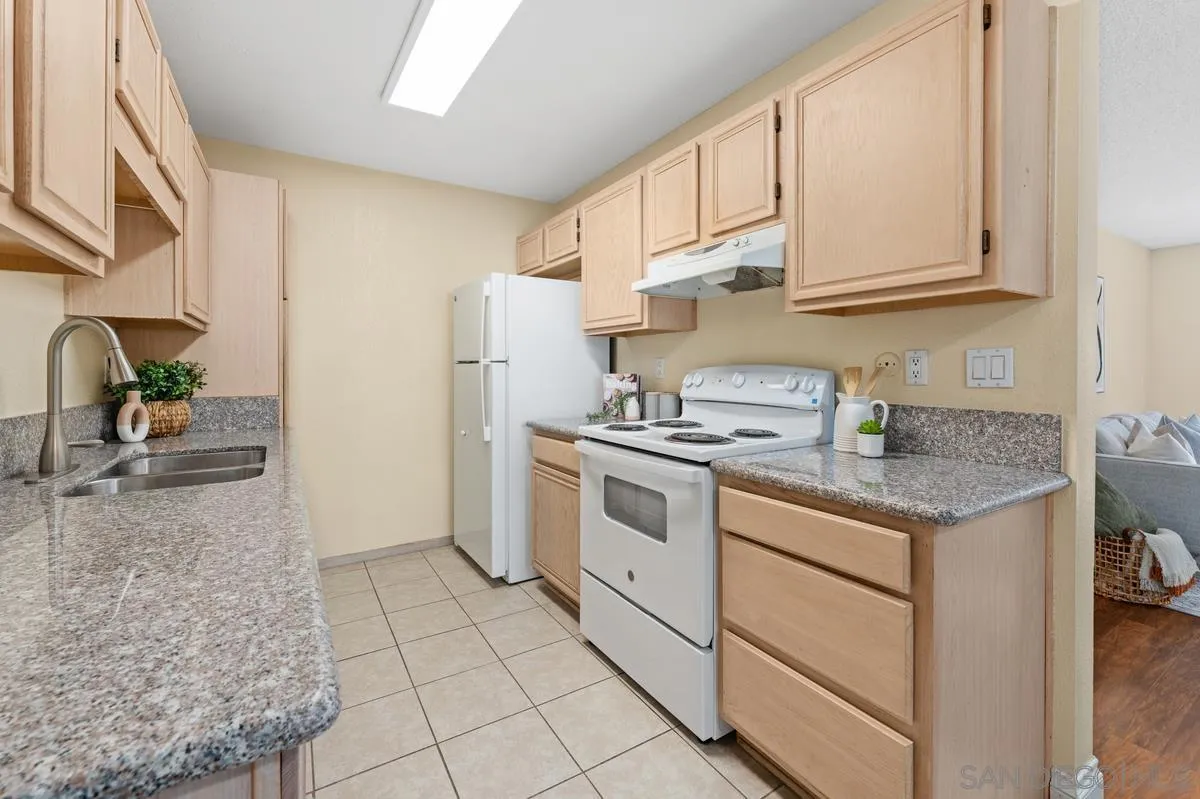 2332 Hosp Way, Unit 207 Carlsbad, CA 92008 - Photo 9 of 31 a kitchen with granite countertop a sink stove and cabinets