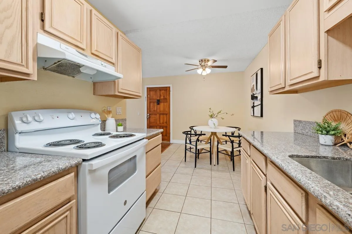 2332 Hosp Way, Unit 207 Carlsbad, CA 92008 - Photo 10 of 31 a kitchen with granite countertop cabinets a sink and a stove