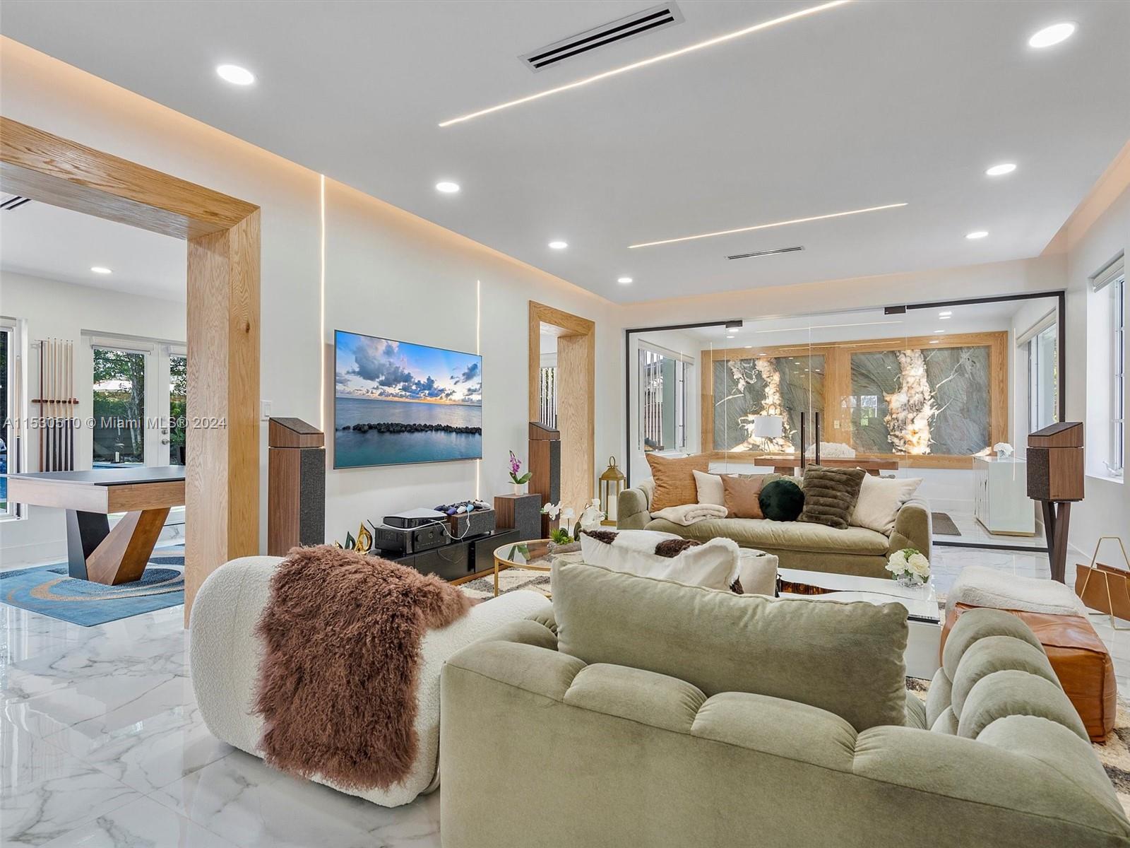 4431 Alton Road, Unit 1 Miami Beach, FL 33140 - Photo 1 of 60 a living room with furniture ceiling fan and a large window