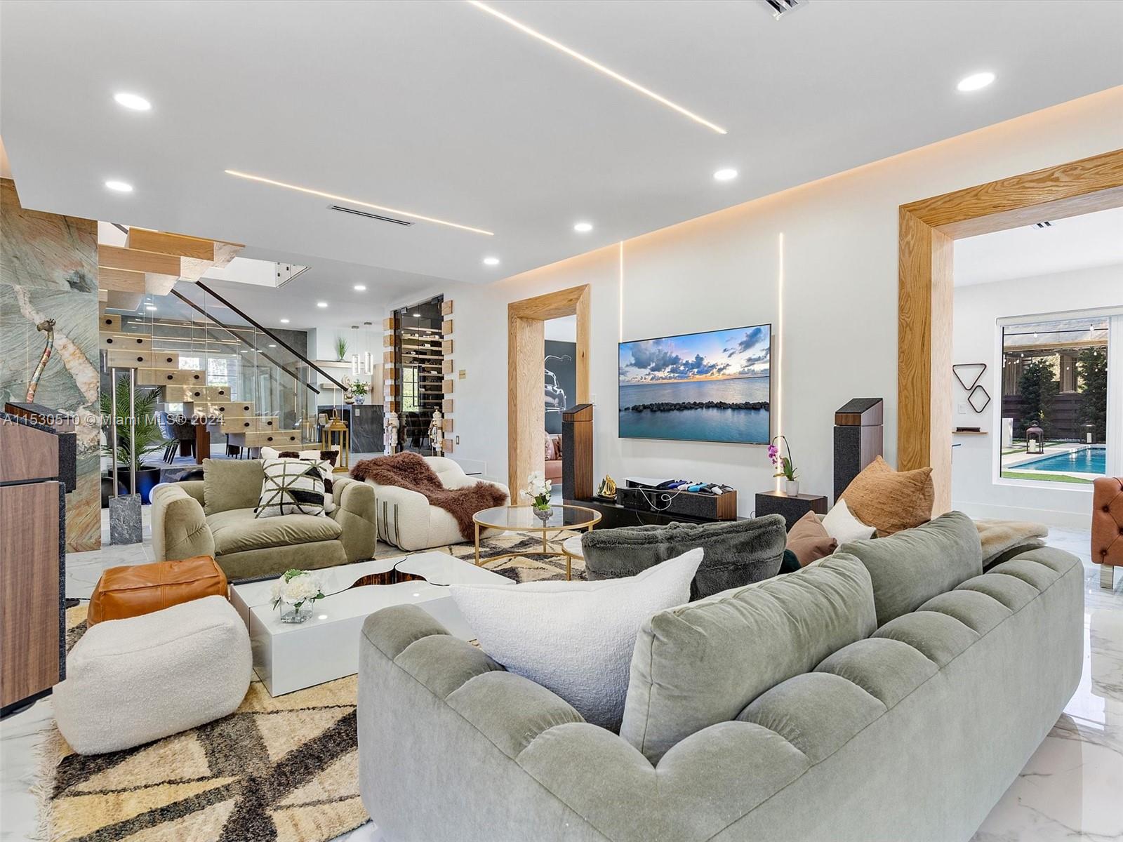 4431 Alton Road, Unit 1 Miami Beach, FL 33140 - Photo 11 of 60 a living room with furniture and a large mirror