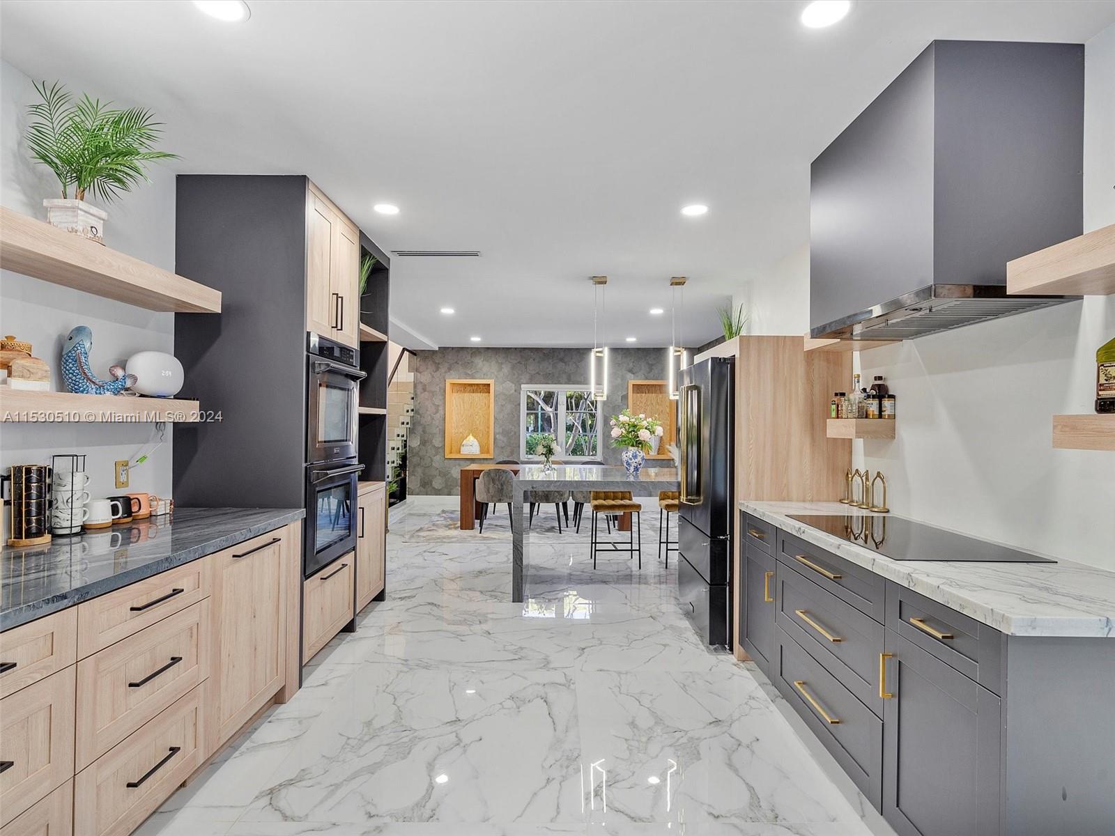 4431 Alton Road, Unit 1 Miami Beach, FL 33140 - Photo 21 of 60 a large kitchen with kitchen island a counter top space a sink stainless steel appliances and cabinets