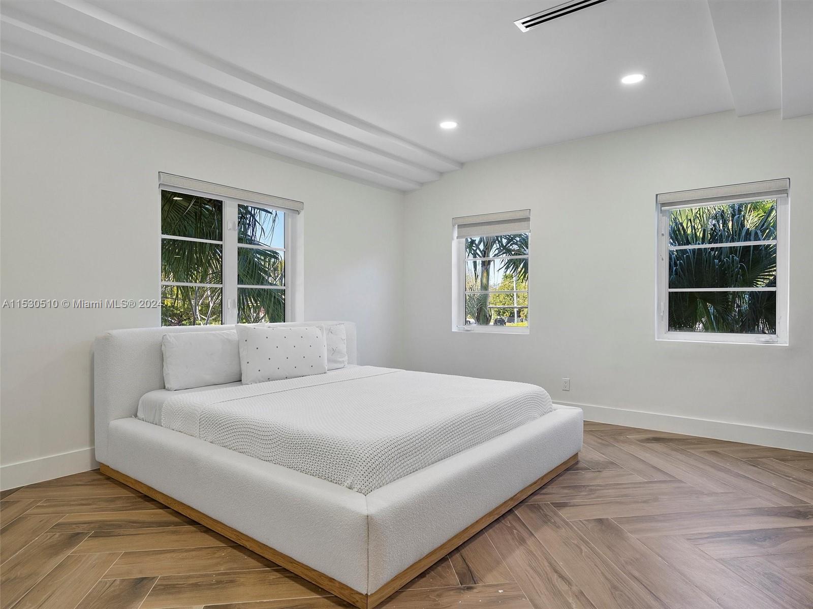 4431 Alton Road, Unit 1 Miami Beach, FL 33140 - Photo 26 of 60 a bedroom with a large bed and a window