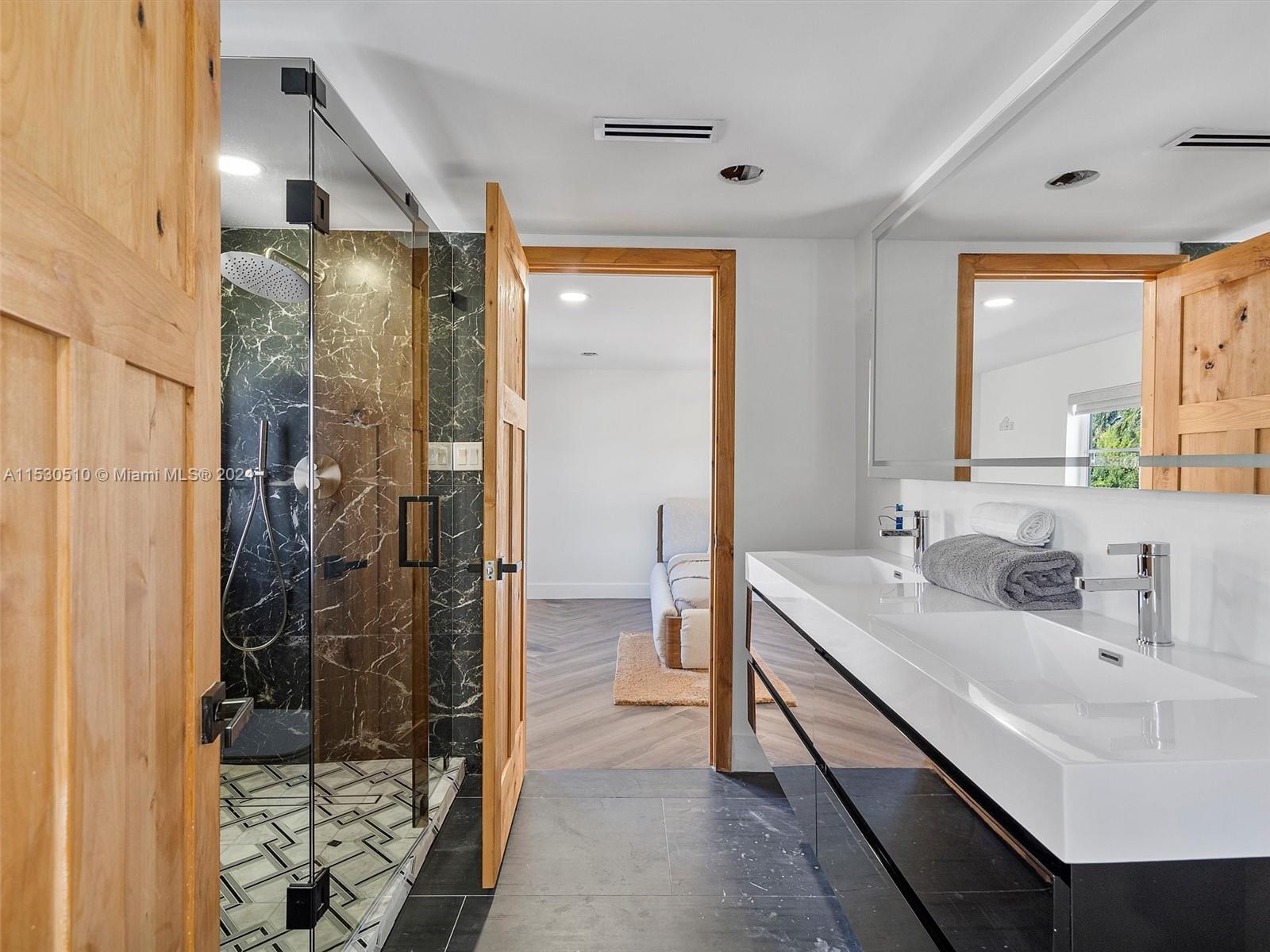 4431 Alton Road, Unit 1 Miami Beach, FL 33140 - Photo 28 of 60 a bathroom with a double vanity sink mirror and shower