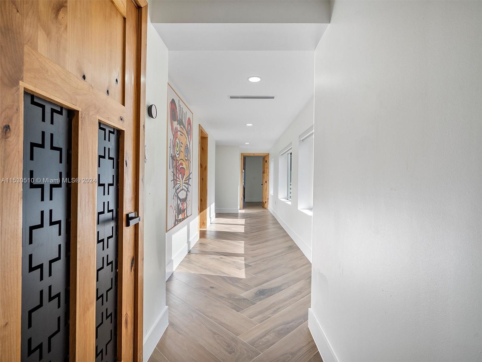 4431 Alton Road, Unit 1 Miami Beach, FL 33140 - Photo 30 of 60 a view of a hallway with wooden floor and staircase