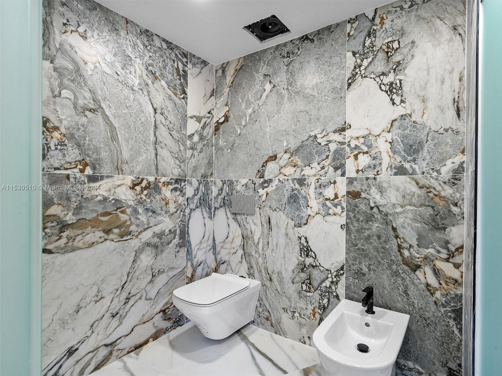 4431 Alton Road, Unit 1 Miami Beach, FL 33140 - Photo 35 of 60 a bathroom with a toilet and a shower curtain