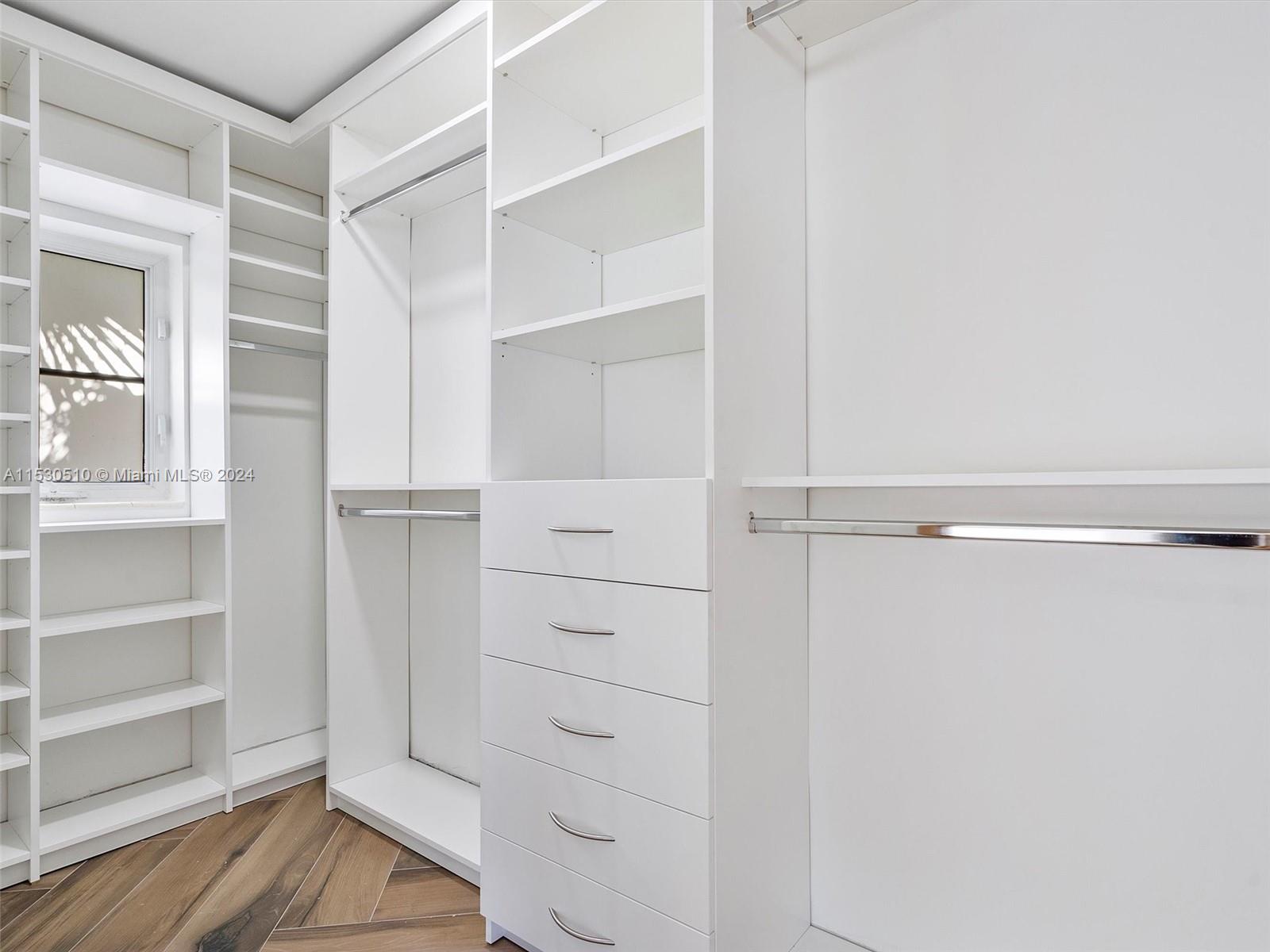 4431 Alton Road, Unit 1 Miami Beach, FL 33140 - Photo 42 of 60 a view of walk in closet with empty racks