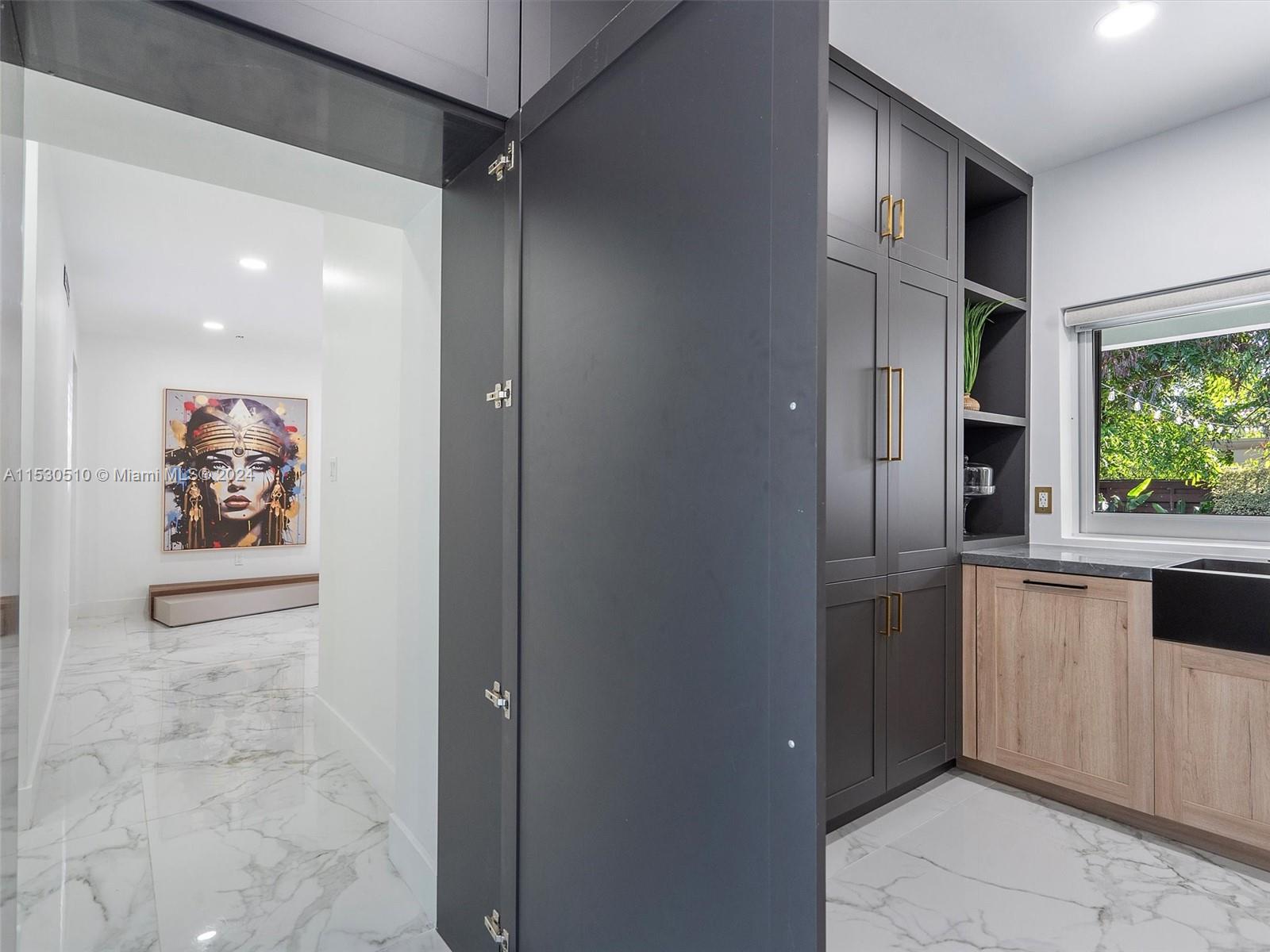 4431 Alton Road, Unit 1 Miami Beach, FL 33140 - Photo 44 of 60 a view of a refrigerator in kitchen and an empty room