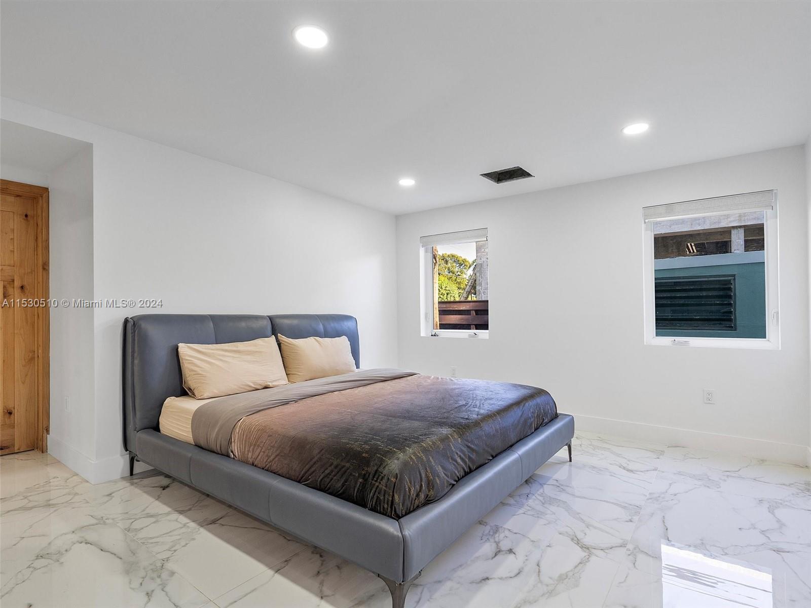 4431 Alton Road, Unit 1 Miami Beach, FL 33140 - Photo 45 of 60 a large bedroom with a bed and a window