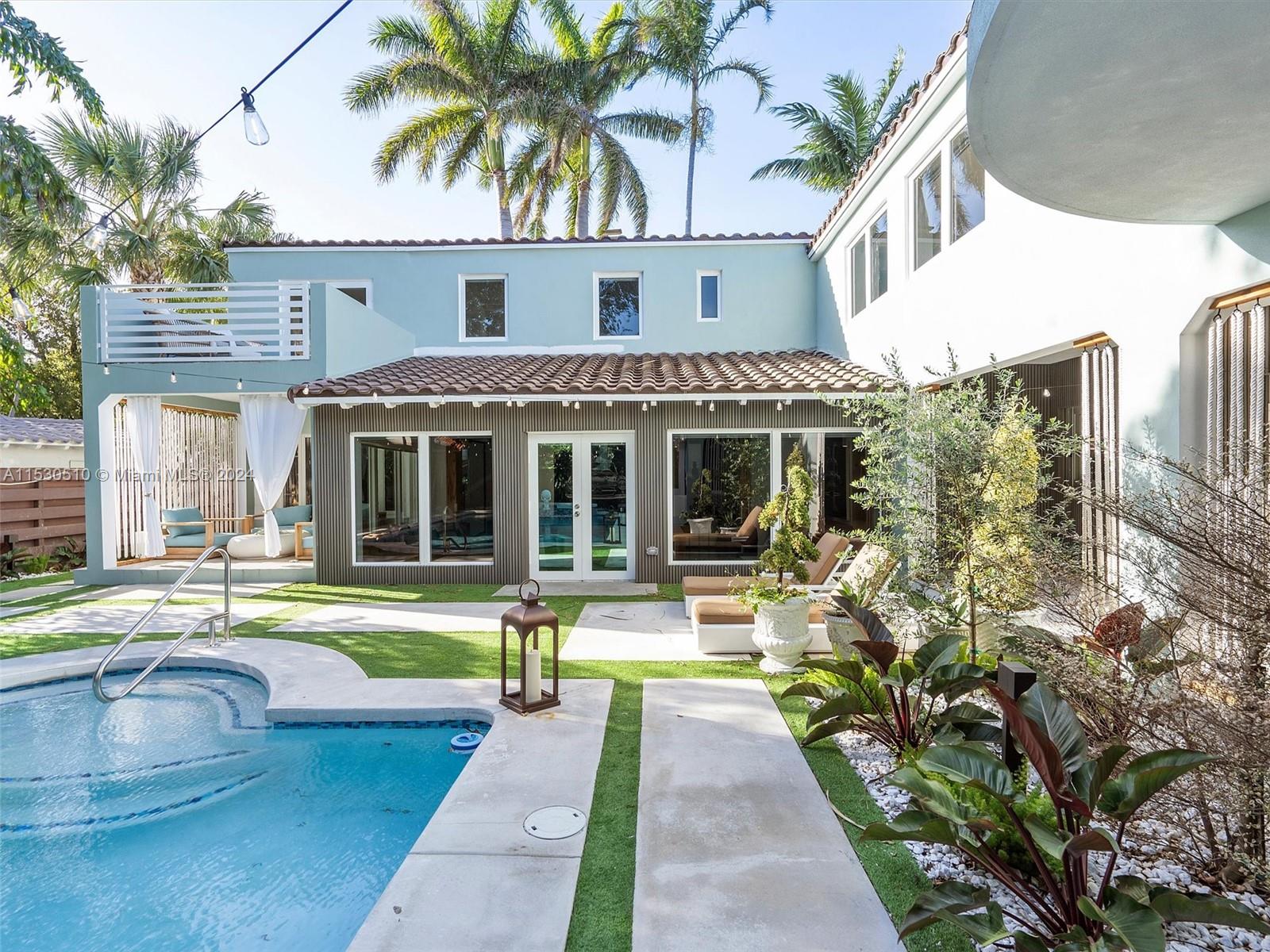 4431 Alton Road, Unit 1 Miami Beach, FL 33140 - Photo 51 of 60 a front view of a house with swimming pool having outdoor seating