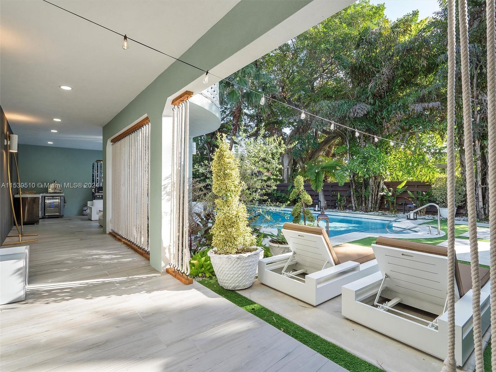 4431 Alton Road, Unit 1 Miami Beach, FL 33140 - Photo 55 of 60 a view of a patio with couches chairs and potted plants