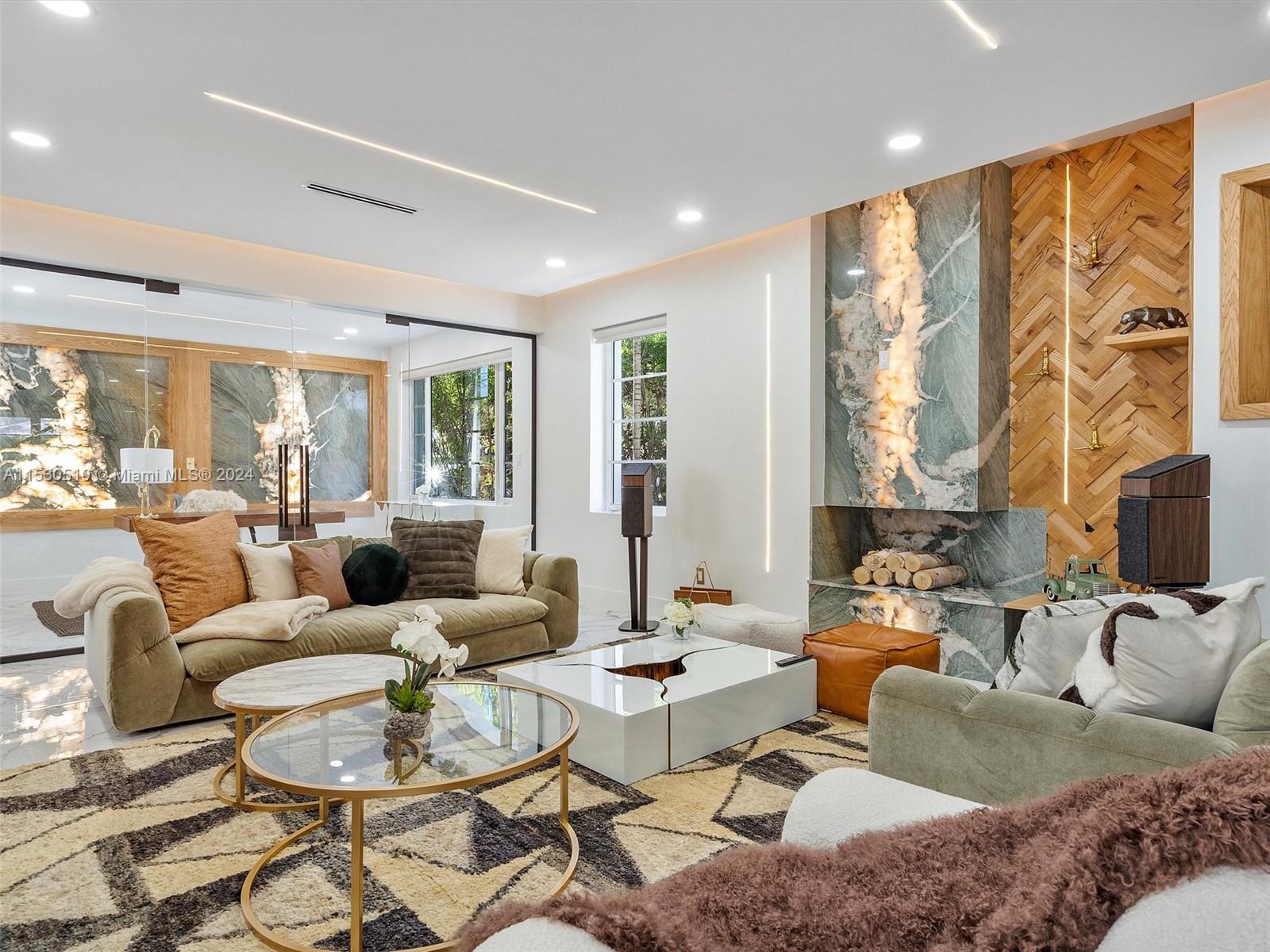 4431 Alton Road, Unit 1 Miami Beach, FL 33140 - Photo 6 of 60 a living room with fireplace furniture and a large window