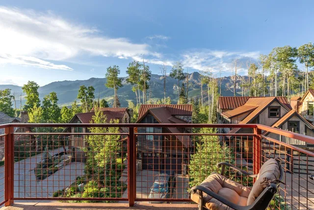 a view of a chairs and table in the balcony
