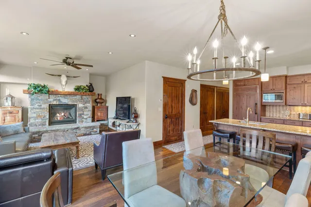 a living room with lots of furniture and kitchen view