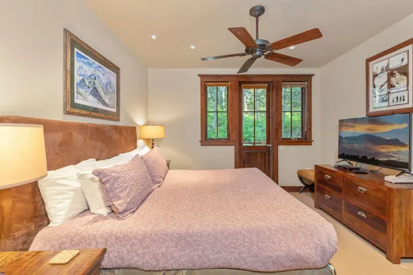 a bedroom with a bed and a flat screen tv