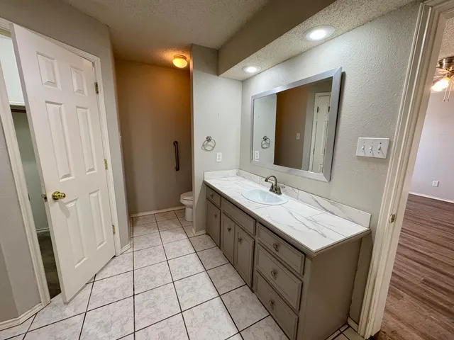 a bathroom with a double vanity sink a mirror and a bathtub