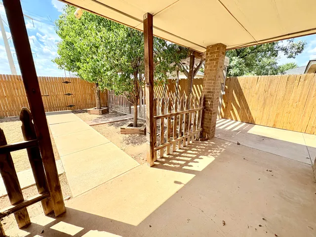 a view of a porch with wooden floor and fence