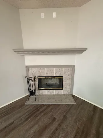 a living room with a fireplace and a wooden floor