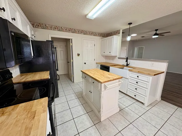 a utility room with cabinets washer and dryer