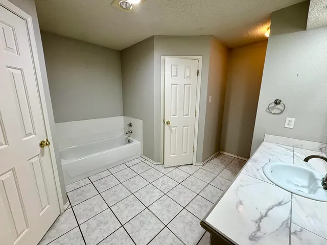 a bathroom with a bathtub and shower