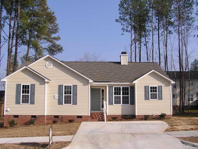 124 Grassy Rio Lane Garner, NC 27529 - Photo 1 of 1 a front view of a house with a garden