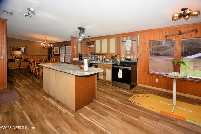 a utility room with dryer washer and a view of living room