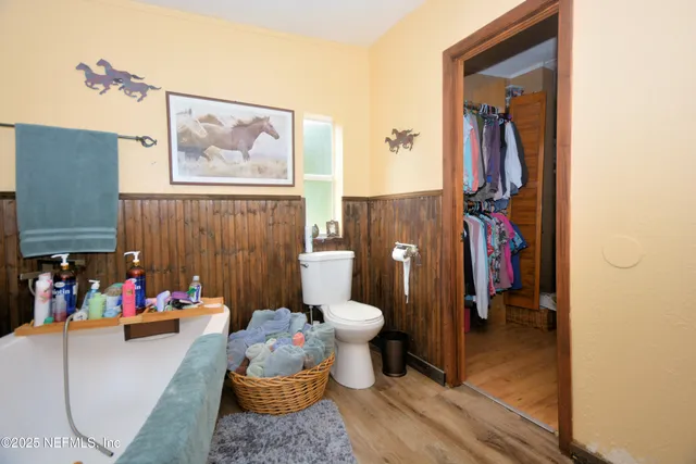 a bathroom with a sink and mirror with toilet